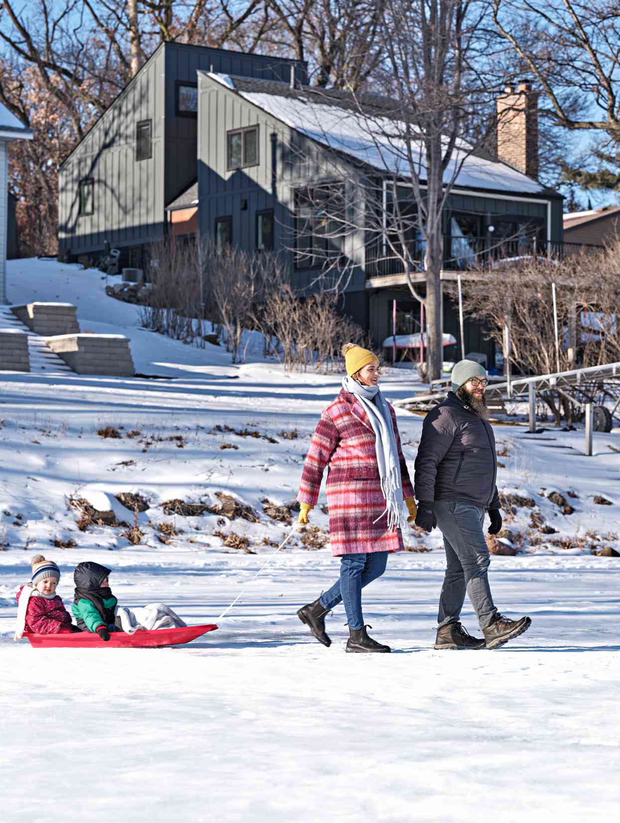 family pulling children on sled