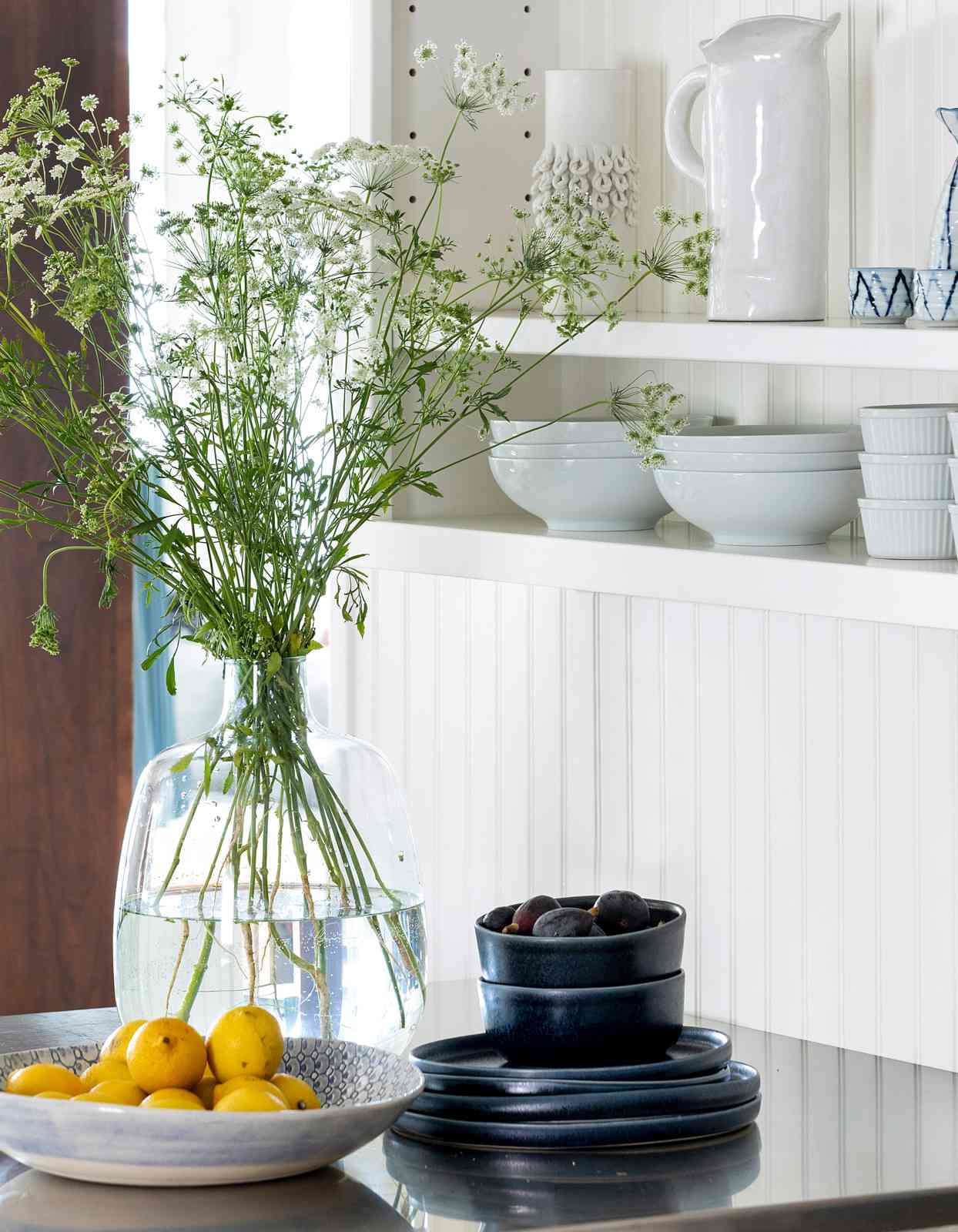 kitchen with beadboard walls and stainless-steel peninsula