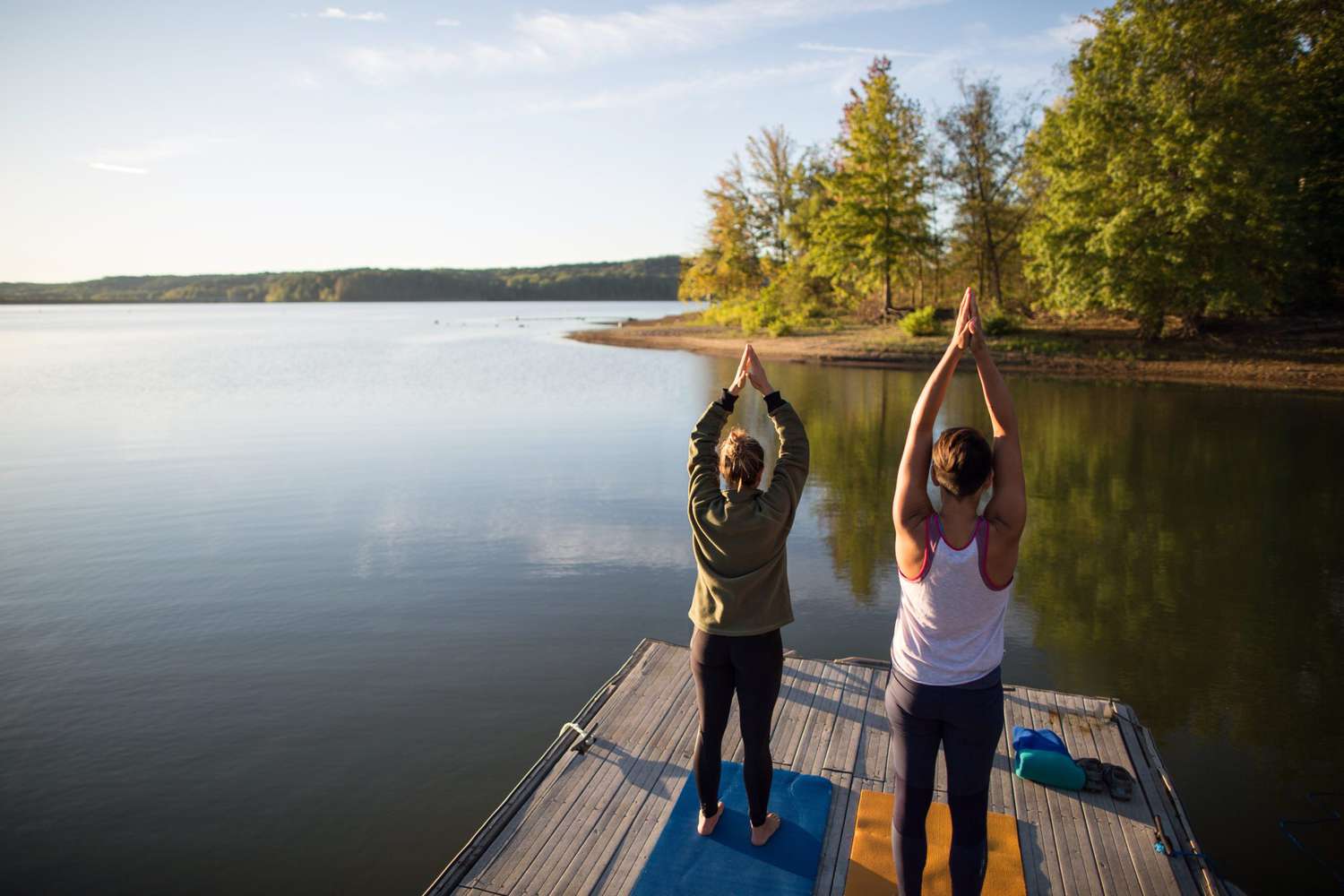 Two people doing yoga poses on dock at Lake Monroe Indiana