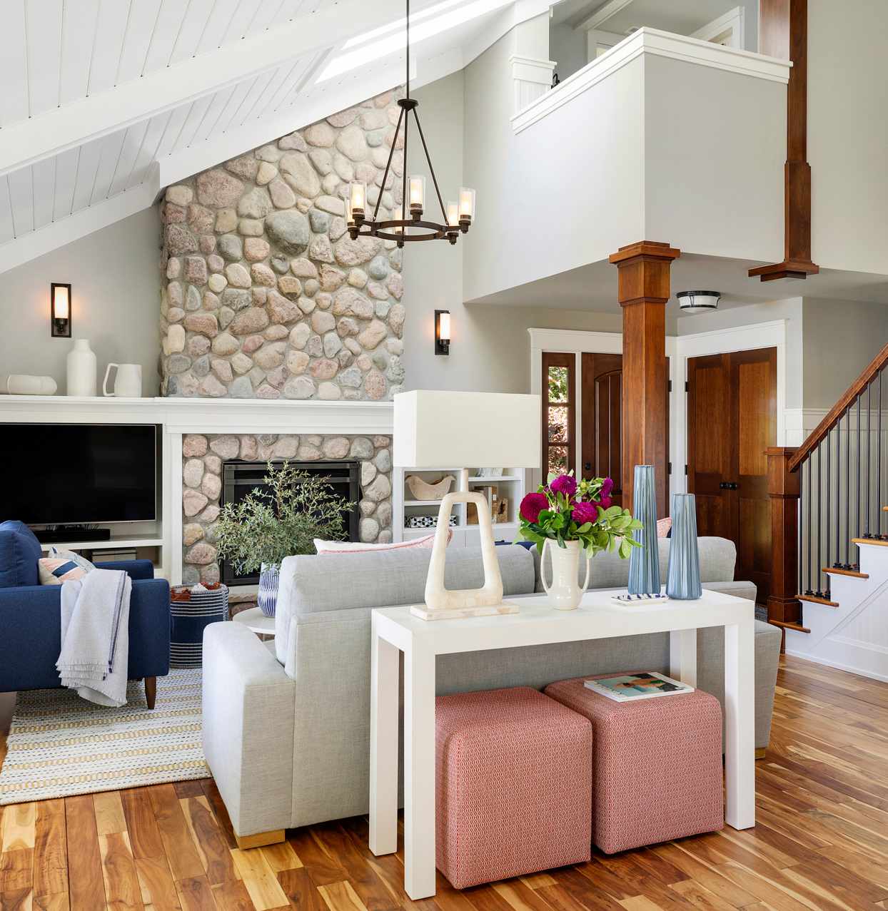 living room with stone fireplace and bronze lighting