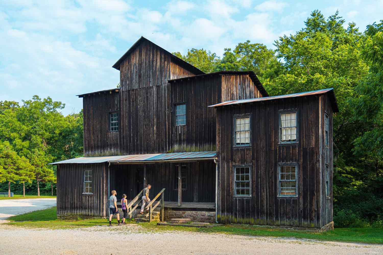 People walking into historic wooden building at Montauk State Park, Missouri