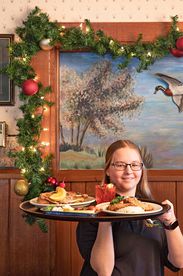 the duck inn waitress with tray of food